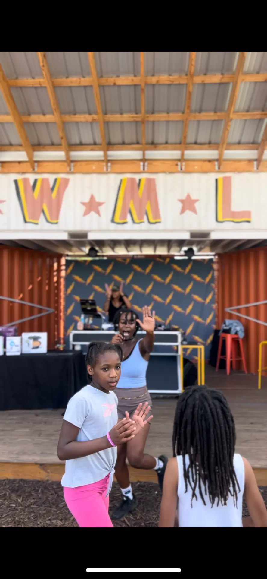 Young dancers performing together on an outdoor stage